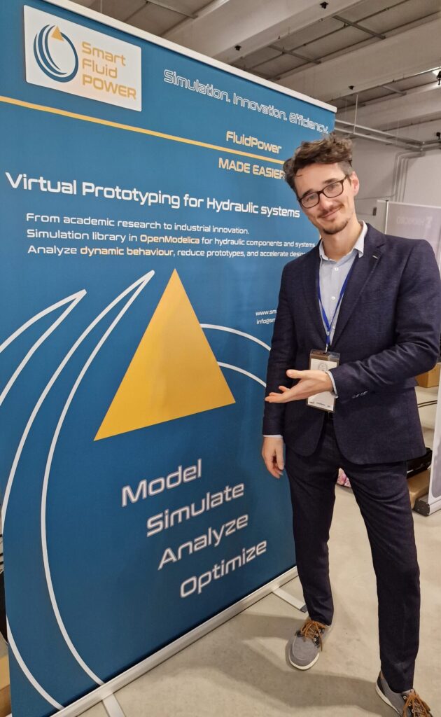 marco rizzoli from smartfluidpower booth at hub meccatronica 2025 in turin